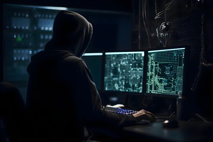 Hacker in hood stealing data from server room. Cybercrime concep